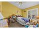 This is a bedroom with a ceiling fan and lots of toys at 378 Wood Chuck Ave, Tarpon Springs, FL 34689