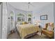 Tranquil bedroom with large windows, a plush bed, and a cozy seating area offering a serene retreat at 378 Wood Chuck Ave, Tarpon Springs, FL 34689