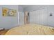 Bedroom features include a double closet, painting, open door to walk-in closet and ensuite bathroom at 378 Wood Chuck Ave, Tarpon Springs, FL 34689