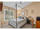 Bedroom with four poster bed, shuttered windows providing natural light and comfortable feel at 378 Wood Chuck Ave, Tarpon Springs, FL 34689