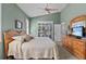 Bedroom with shuttered windows, a ceiling fan, a dresser, a bed, and a TV, providing relaxation at 378 Wood Chuck Ave, Tarpon Springs, FL 34689
