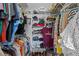 A walk-in closet with extensive shelving, hanging space, and various clothes neatly organized at 378 Wood Chuck Ave, Tarpon Springs, FL 34689