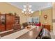 Inviting dining room featuring elegant chandelier lighting and a view into the living room at 378 Wood Chuck Ave, Tarpon Springs, FL 34689