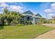 Charming single-story home with a well-manicured lawn, mature trees, and lush landscaping at 378 Wood Chuck Ave, Tarpon Springs, FL 34689