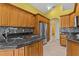 Spacious kitchen with stainless steel appliances, granite countertops, tile backsplash, and ample storage for the home chef at 378 Wood Chuck Ave, Tarpon Springs, FL 34689