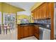 Kitchen area featuring stainless steel appliances, modern granite countertops, and ample natural light from the adjacent dining area at 378 Wood Chuck Ave, Tarpon Springs, FL 34689