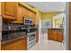 Updated kitchen featuring stainless steel appliances, mosaic tile backsplash, and a seamless connection to the dining space at 378 Wood Chuck Ave, Tarpon Springs, FL 34689