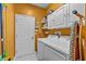 The laundry room has a washer, dryer, and white cabinets for storage at 378 Wood Chuck Ave, Tarpon Springs, FL 34689