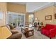 Spacious living room filled with natural light, comfortable seating, and a view to the backyard at 378 Wood Chuck Ave, Tarpon Springs, FL 34689