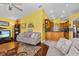Well-lit living room offering seamless access to the kitchen, combining style and functionality for a modern lifestyle at 378 Wood Chuck Ave, Tarpon Springs, FL 34689