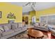 Spacious living room with hardwood floors, neutral furniture, and a view of the dining area, perfect for modern living at 378 Wood Chuck Ave, Tarpon Springs, FL 34689