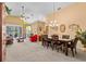 Open-concept living and dining area with carpet, stylish furniture, and lots of natural light at 378 Wood Chuck Ave, Tarpon Springs, FL 34689