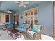 Relaxing screened patio with comfortable wicker seating and stylish decor at 378 Wood Chuck Ave, Tarpon Springs, FL 34689