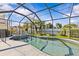 Sparkling pool area enclosed with a screen, surrounded by lush landscaping at 378 Wood Chuck Ave, Tarpon Springs, FL 34689