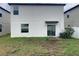 Backyard and exterior elevation with lawn at 3810 Romano Busciglio St, Tampa, FL 33619