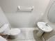 Cozy half bathroom features a toilet and sink, with tile flooring and neutral decor at 3810 Romano Busciglio St, Tampa, FL 33619