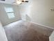 Bedroom offers neutral walls and carpeting, a ceiling fan and a window at 3810 Romano Busciglio St, Tampa, FL 33619