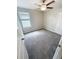 Bedroom featuring neutral paint, gray carpet, closet, ceiling fan, and natural light at 3810 Romano Busciglio St, Tampa, FL 33619