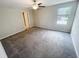 Bedroom with a window, ceiling fan, and carpet at 3810 Romano Busciglio St, Tampa, FL 33619