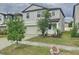 Two-story home with a two-car garage, landscaping and sidewalks at 3810 Romano Busciglio St, Tampa, FL 33619