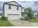 Charming two-story home featuring a two-car garage, with blue colored front door at 3810 Romano Busciglio St, Tampa, FL 33619