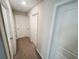 Hallway with multiple doors and carpet flooring at 3810 Romano Busciglio St, Tampa, FL 33619