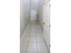 Tiled hallway with white trim and a view of the staircase and other rooms at 3810 Romano Busciglio St, Tampa, FL 33619