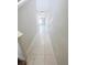 Tiled hallway leading to open living space with natural light and neutral paint at 3810 Romano Busciglio St, Tampa, FL 33619