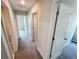 Hallway with multiple white doors and gray carpet flooring for a clean and modern aesthetic at 3810 Romano Busciglio St, Tampa, FL 33619