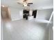 Open concept living room featuring tile floors, ceiling fan, and kitchen with island at 3810 Romano Busciglio St, Tampa, FL 33619