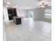 Open-concept living area with tiled floors, modern lighting, and access to outdoor patio at 3810 Romano Busciglio St, Tampa, FL 33619