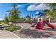 Community playground with slides, climbing structures, and a safety-surfaced ground at 3810 Romano Busciglio St, Tampa, FL 33619