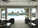View from covered patio looking out to community pool with lounge chairs and umbrellas at 3810 Romano Busciglio St, Tampa, FL 33619