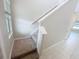 Carpeted staircase with white banister and a view to the upper level and lower floor at 3810 Romano Busciglio St, Tampa, FL 33619