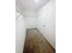 A walk-in closet with metal shelving and neutral carpeting offers ample storage space at 3810 Romano Busciglio St, Tampa, FL 33619