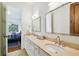 Bathroom featuring double sinks with stone countertops and a view into an adjacent bedroom at 4313 W Beachway Dr, Tampa, FL 33609