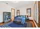 Comfortable bedroom with wood floors, window shutters, and a blue area rug at 4313 W Beachway Dr, Tampa, FL 33609
