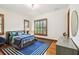 Comfortable bedroom with wood floors, a queen bed, and natural light from the windows at 4313 W Beachway Dr, Tampa, FL 33609
