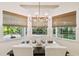 Dining area with natural light, modern chandelier, and outdoor views at 4313 W Beachway Dr, Tampa, FL 33609