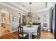 Elegant dining room features a modern chandelier, large windows, and stylish decor at 4313 W Beachway Dr, Tampa, FL 33609