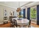 Elegant dining room features a modern chandelier, large windows, and stylish decor at 4313 W Beachway Dr, Tampa, FL 33609