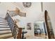 Grand foyer with staircase, decorative railing, and a view into the dining room at 4313 W Beachway Dr, Tampa, FL 33609