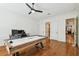 Bright game room featuring a custom pool table, hardwood floors, and modern lighting at 4313 W Beachway Dr, Tampa, FL 33609