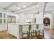 Bright kitchen with white cabinetry, a center island with seating, and stainless steel appliances at 4313 W Beachway Dr, Tampa, FL 33609