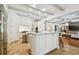 Bright, open kitchen with white cabinets, stainless steel appliances, and center island with seating and decorative beams at 4313 W Beachway Dr, Tampa, FL 33609