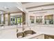 Open kitchen with stainless steel sink, marble countertops, and views into the living and dining areas at 4313 W Beachway Dr, Tampa, FL 33609