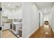 A spacious laundry room featuring front load washer and dryer units and ample cabinet space at 4313 W Beachway Dr, Tampa, FL 33609