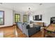 Open living room with hard wood floors, large couch, entertainment center, and a roll and score game at 4313 W Beachway Dr, Tampa, FL 33609