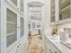Bright, long pantry with white cabinetry, appliances, and tile flooring at 4313 W Beachway Dr, Tampa, FL 33609