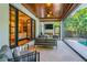 Relaxing screened patio has comfortable seating, a TV, and a tranquil view of the lush landscaping surrounding a beautiful pool at 4313 W Beachway Dr, Tampa, FL 33609